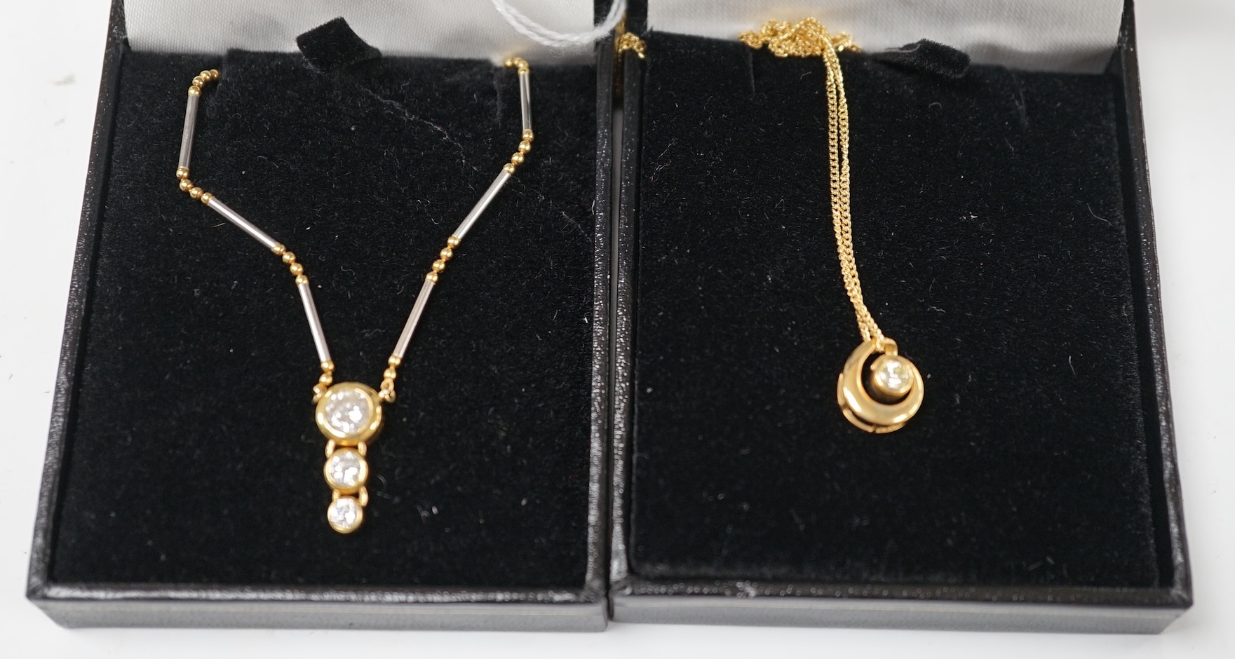A modern yellow and white metal (stamped 18kt and Pt850), graduated three stone diamond set pendant necklace, 42cm, gross weight 7.1 grams and a an Italian Uno-A-Erre 18ct gold and solitaire diamond set necklace, 46cm, g